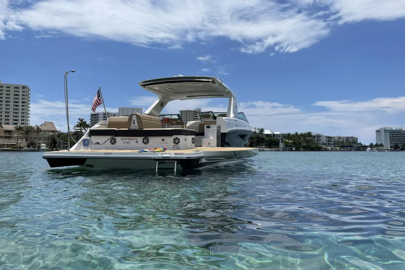 Slide: The Image of 2023 Sea Ray SLX 400 yacht on clear water with cityscape background. - 15