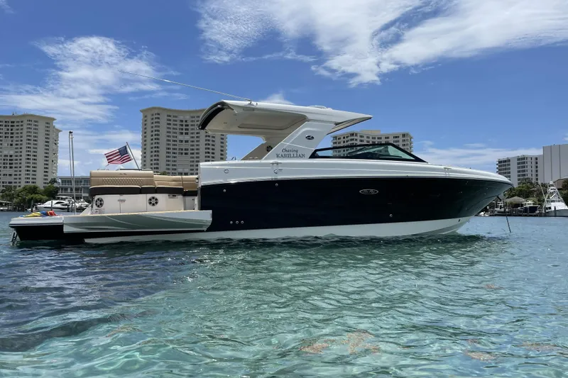 Slide: The Image of 2023 Sea Ray SLX 400 boat on clear water with city skyline background. - 16