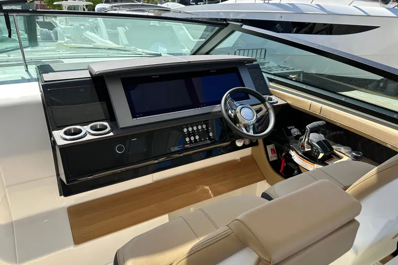 Slide: The Image of 2023 Sea Ray SLX 400 helm with modern controls and sleek design. - 2