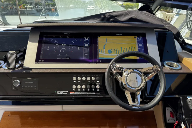 Slide: The Image of 2023 Sea Ray SLX 400 helm with advanced navigation displays and controls. - 23