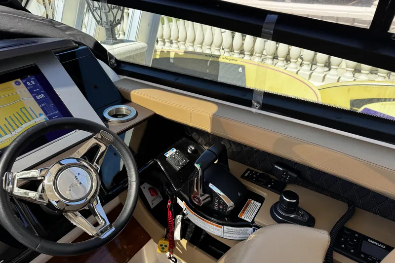 Slide: The Image of Helm of 2023 Sea Ray SLX 400 with modern controls and navigation display. - 25