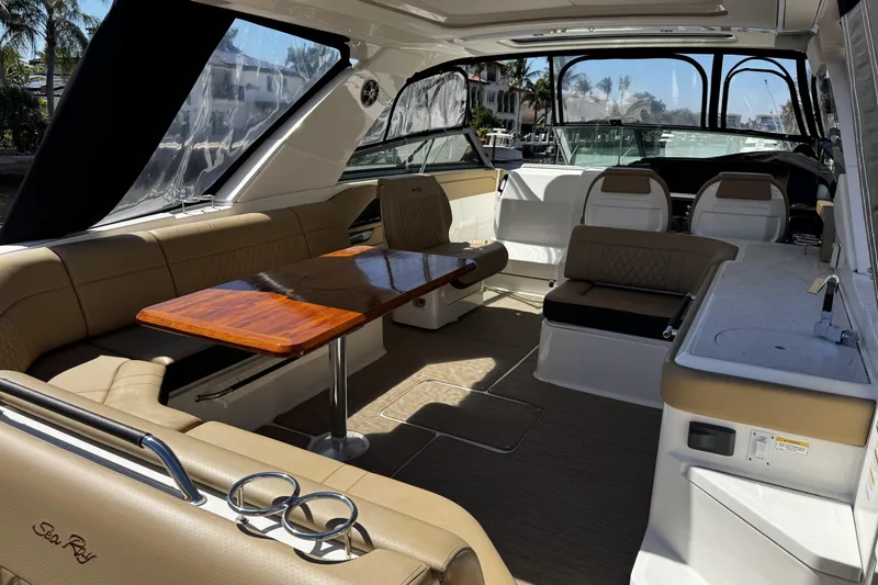 Slide: The Image of Luxurious interior of 2023 Sea Ray SLX 400 boat with elegant seating and wooden table. - 32