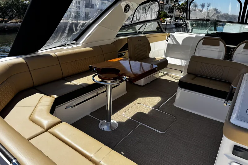 Slide: The Image of 2023 Sea Ray SLX 400 interior with luxurious seating and elegant wooden table. - 33