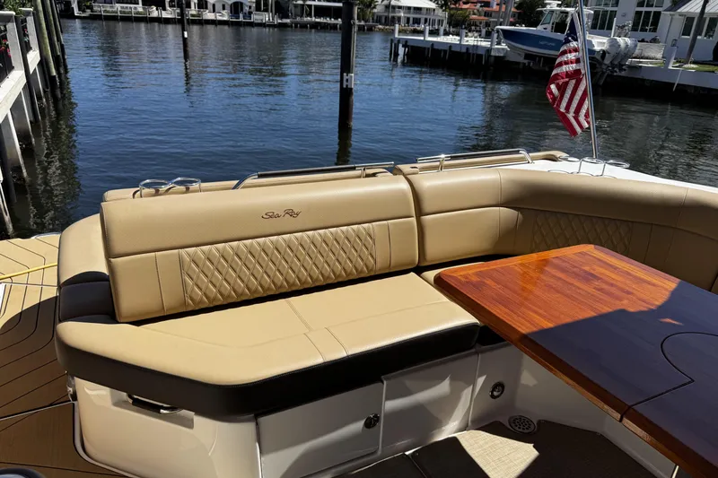 Slide: The Image of Luxurious seating area on 2023 Sea Ray SLX 400 boat with wooden table and waterfront view. - 35