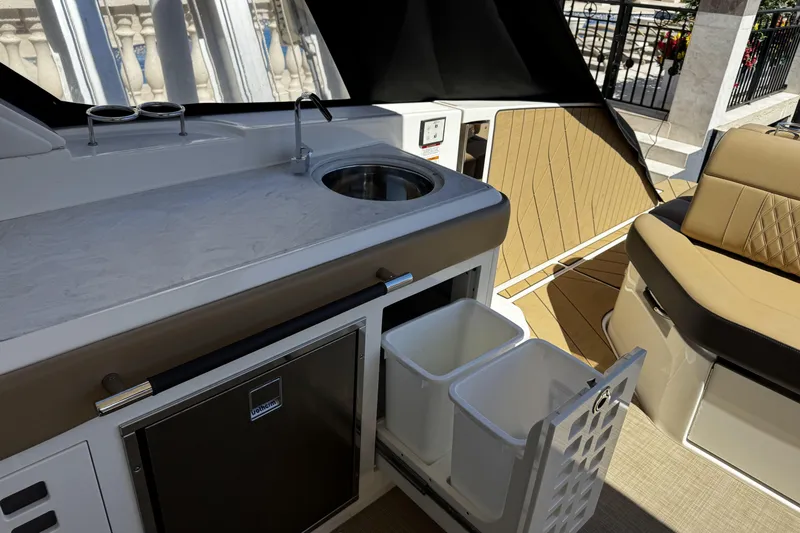 Slide: The Image of Luxurious 2023 Sea Ray SLX 400 yacht interior with kitchenette and seating area. - 37
