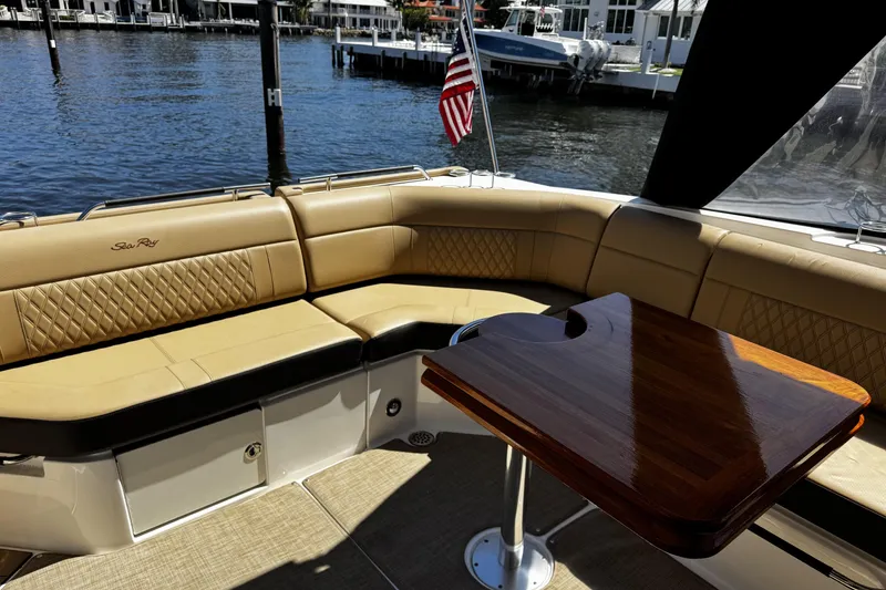 Slide: The Image of Luxurious seating area on 2023 Sea Ray SLX 400 yacht with wooden table and waterfront view. - 41