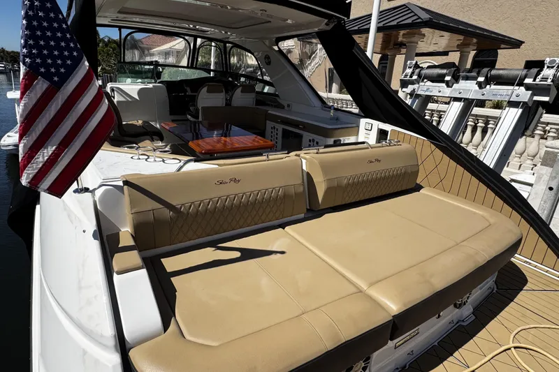 Slide: The Image of 2023 Sea Ray SLX 400 yacht with luxurious seating and American flag. - 43