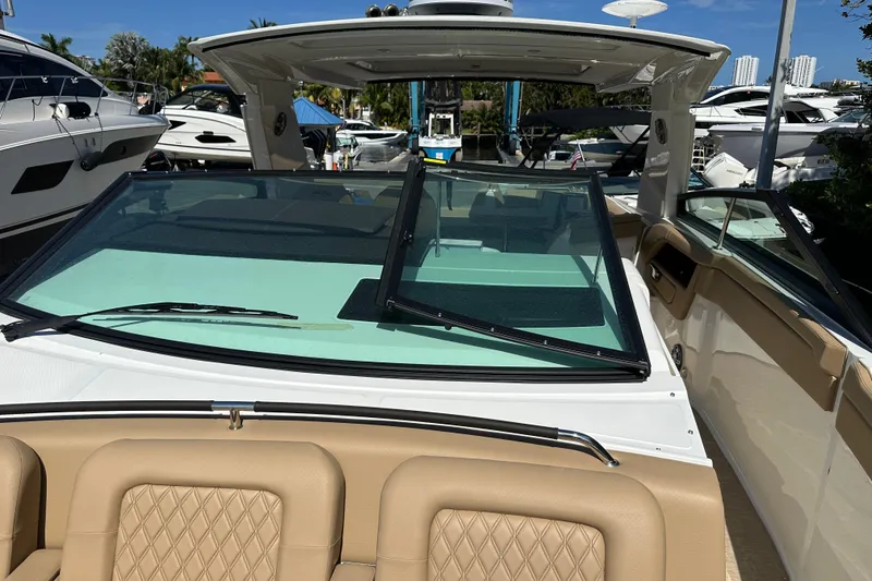 Slide: The Image of 2023 Sea Ray SLX 400 boat with tan seating and sleek windshield design. - 51