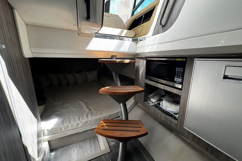 Slide: The Image of Interior of 2023 Sea Ray SLX 400 yacht with wooden steps and modern amenities. - 57