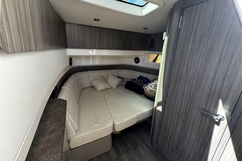 Slide: The Image of Interior cabin of 2023 Sea Ray SLX 400 with modern furnishings and skylight. - 59