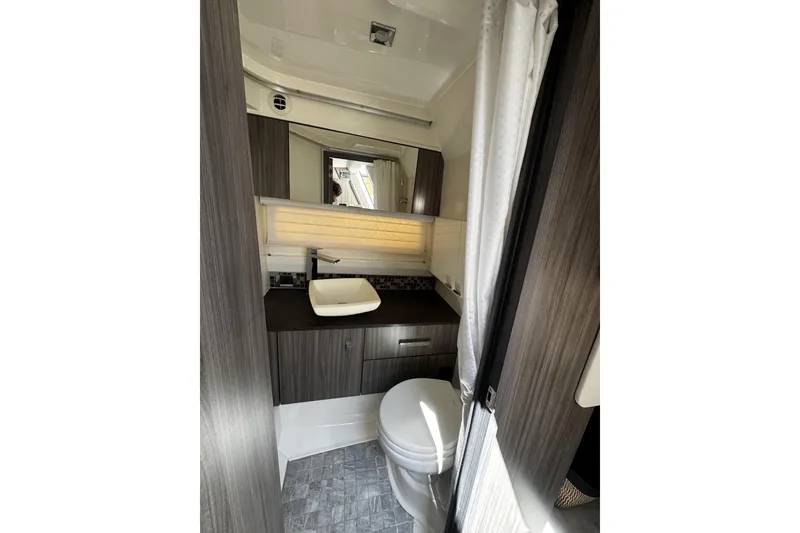 Slide: The Image of Luxurious bathroom interior of 2023 Sea Ray SLX 400 boat, featuring modern fixtures and elegant design. - 62