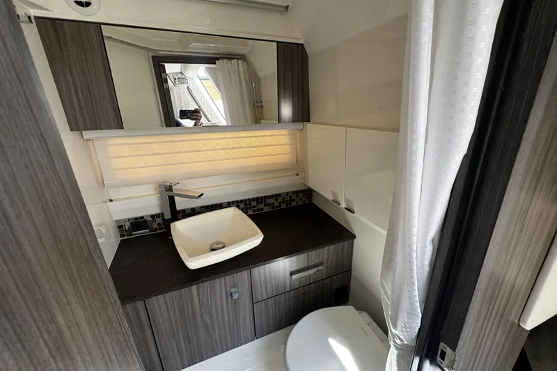 Slide: The Image of Luxurious bathroom interior of 2023 Sea Ray SLX 400 yacht with modern sink and cabinetry. - 63
