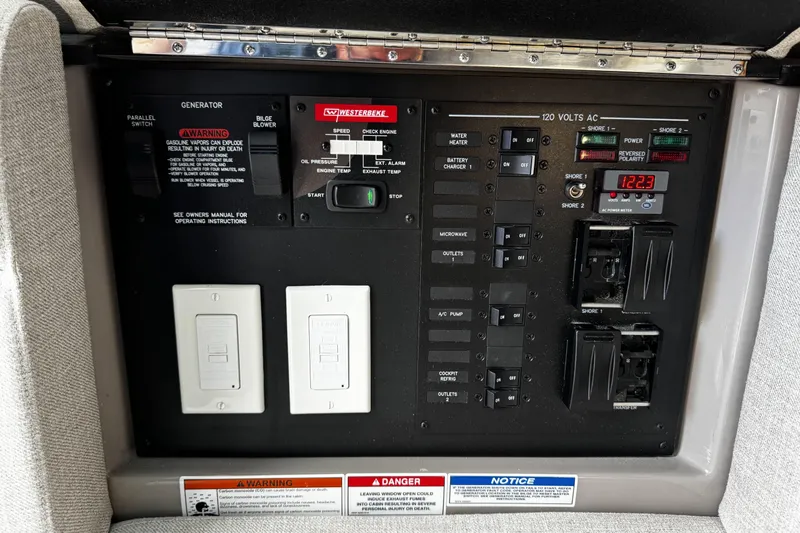 Slide: The Image of Electrical control panel on a 2023 Sea Ray SLX 400 boat, featuring switches and indicators. - 67