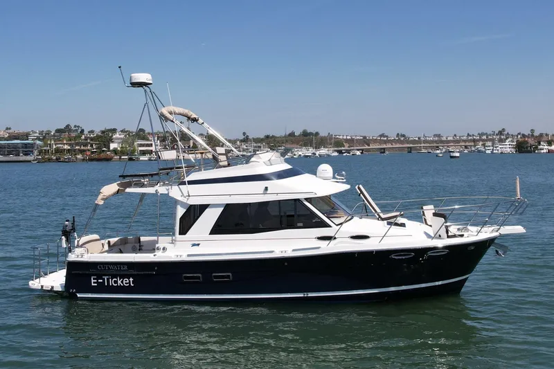The Image of 2015 Cutwater C-30 CB boat on calm water, featuring sleek design and modern amenities. - 1