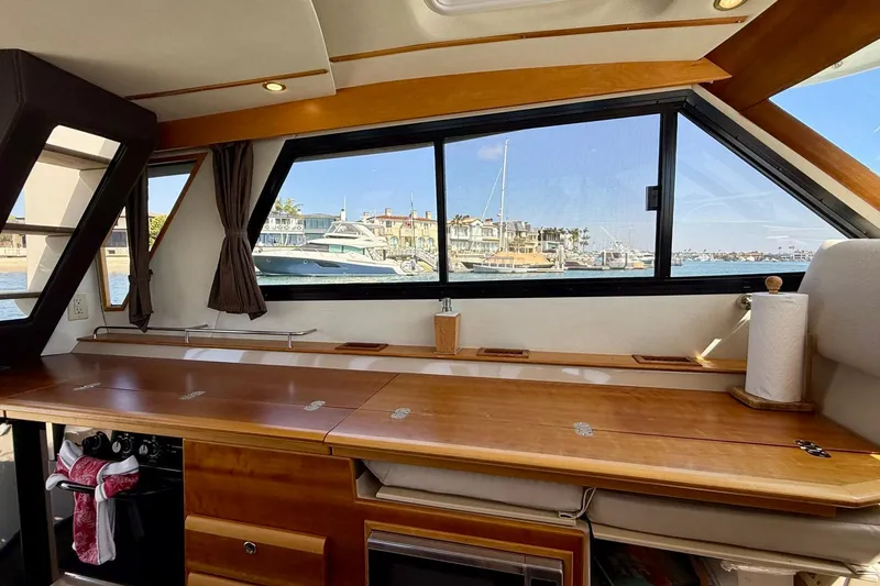 Slide: The Image of Interior of 2015 Cutwater C-30 CB boat with wooden cabinetry and marina view. - 13