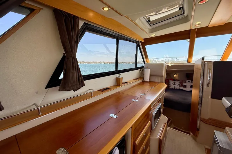 Slide: The Image of Interior of 2015 Cutwater C-30 CB boat with wooden cabinetry and scenic window view. - 15