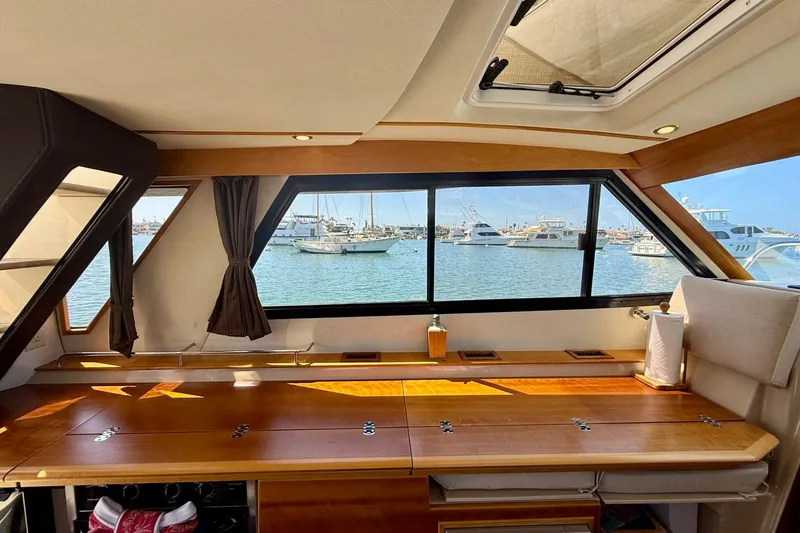 Slide: The Image of Interior view of 2015 Cutwater C-30 CB yacht with harbor view through large windows. - 17