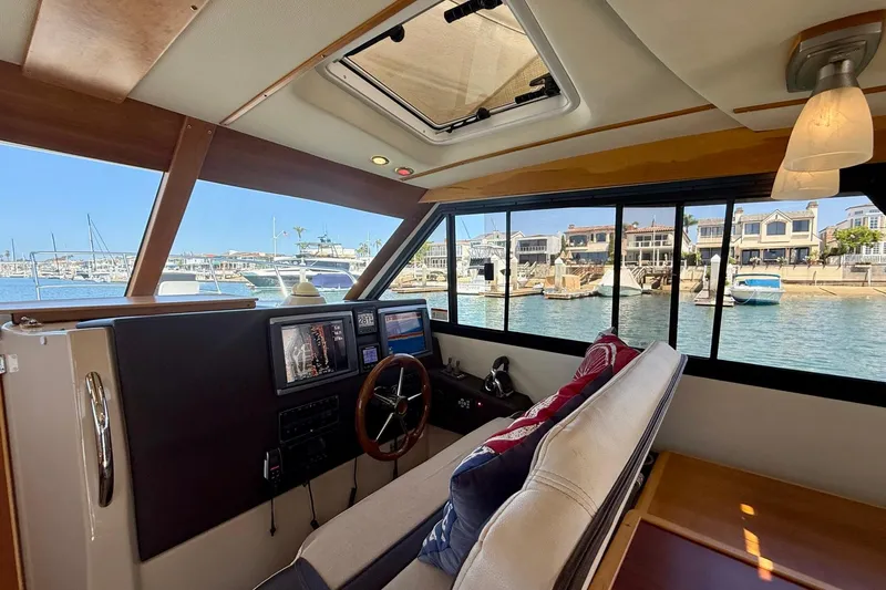 Slide: The Image of Interior view of 2015 Cutwater C-30 CB boat with helm and waterfront scenery. - 18
