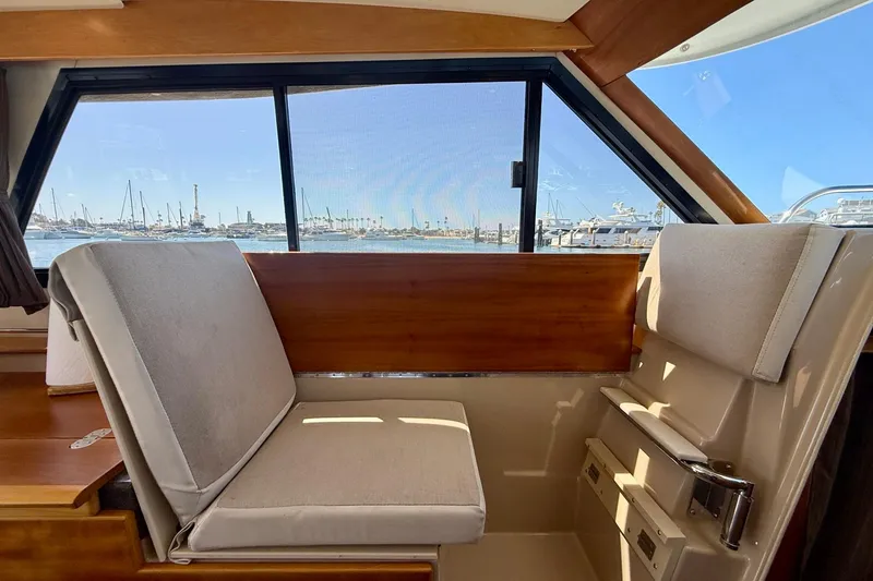 Slide: The Image of Interior view of 2015 Cutwater C-30 CB boat with comfortable seating and marina backdrop. - 19