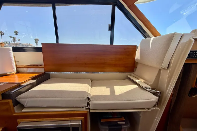 Slide: The Image of Interior of a 2015 Cutwater C-30 CB boat with cushioned seating and wooden accents. - 20