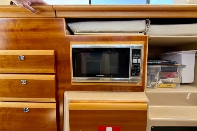 Slide: The Image of 2015 Cutwater C-30 CB interior with microwave and wooden cabinetry. - 26