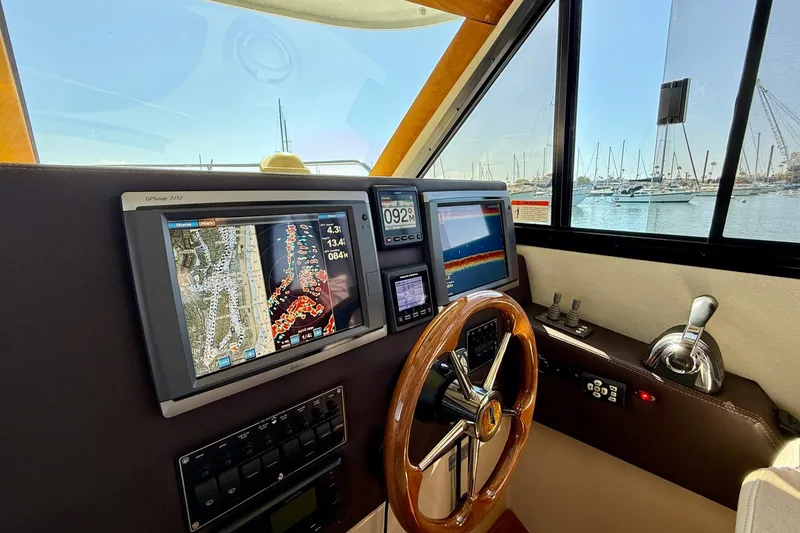 Slide: The Image of Helm of 2015 Cutwater C-30 CB with navigation screens and wooden steering wheel. - 32