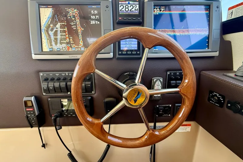 Slide: The Image of Steering wheel and navigation displays on 2015 Cutwater C-30 CB boat dashboard. - 36