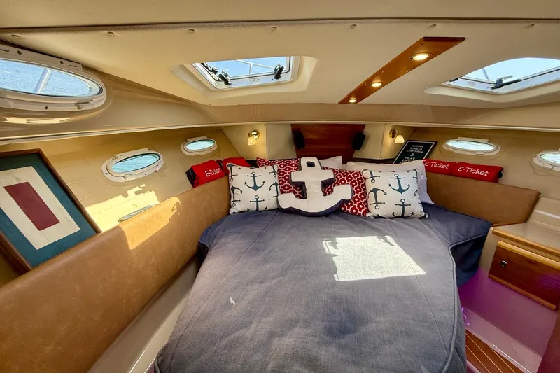Slide: The Image of Cozy cabin interior of 2015 Cutwater C-30 CB with nautical-themed decor and skylights. - 37