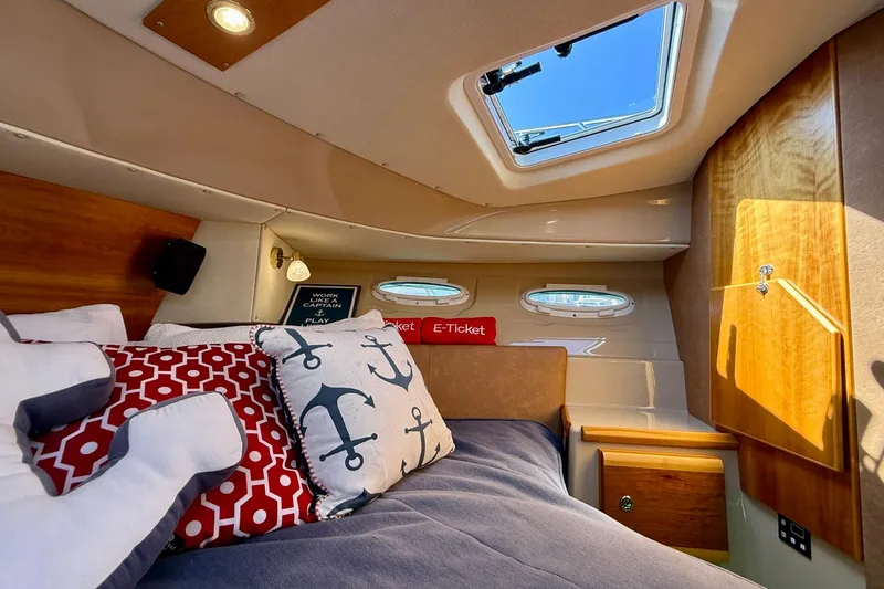 Slide: The Image of Cozy cabin interior of 2015 Cutwater C-30 CB with nautical-themed pillows and skylight. - 39