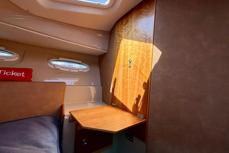 Slide: The Image of Interior cabin of 2015 Cutwater C-30 CB boat with wooden foldable table. - 40