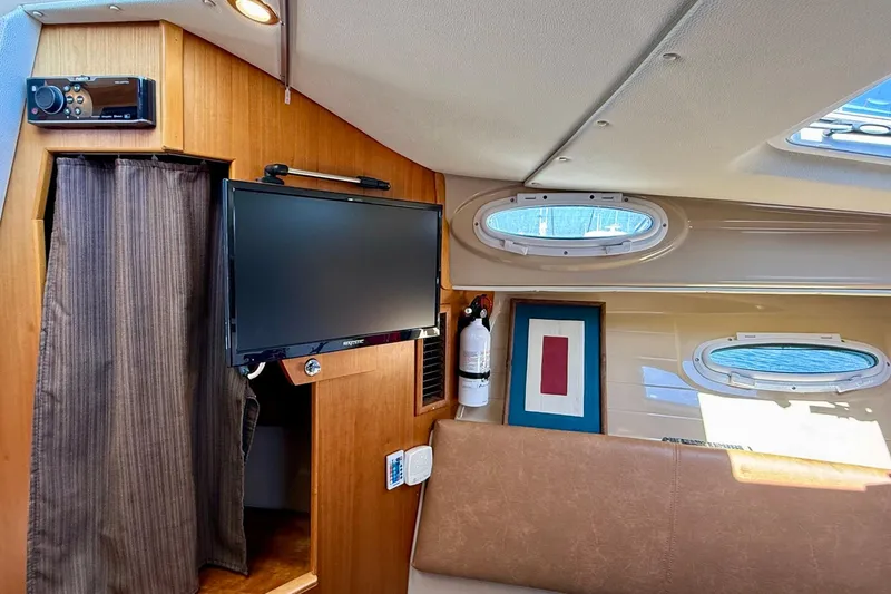 Slide: The Image of Interior of 2015 Cutwater C-30 CB boat with TV, windows, and fire extinguisher. - 41