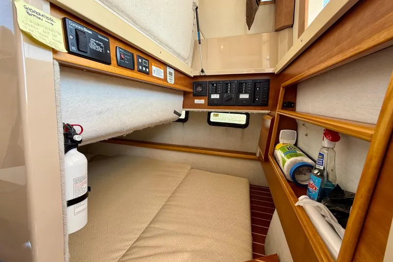 Slide: The Image of 2015 Cutwater C-30 CB cabin interior with control panels and storage shelves. - 45