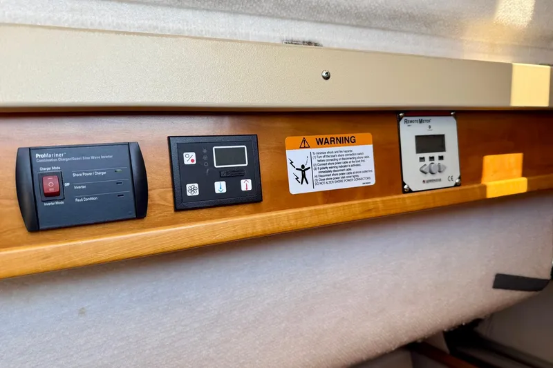 Slide: The Image of Control panel of a 2015 Cutwater C-30 CB boat with warning labels and electronic displays. - 47