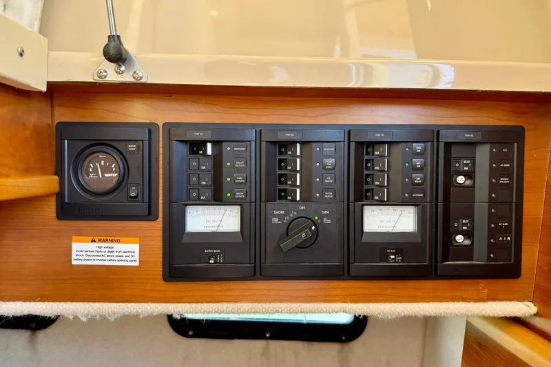 Slide: The Image of Electrical control panel on a 2015 Cutwater C-30 CB boat, featuring gauges and switches. - 48
