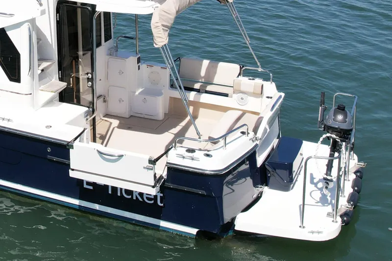 Slide: The Image of 2015 Cutwater C-30 CB boat with spacious deck and seating, floating on water. - 5