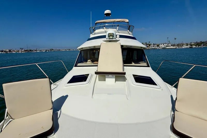 Slide: The Image of 2015 Cutwater C-30 CB yacht on calm water, featuring spacious deck seating. - 50