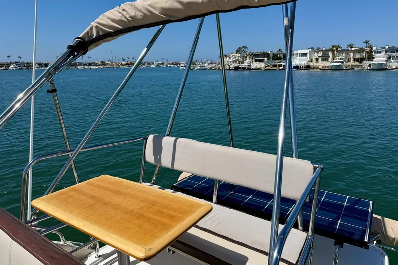 Slide: The Image of 2015 Cutwater C-30 CB boat with seating and table, overlooking a marina. - 55