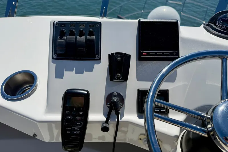 Slide: The Image of Control panel of a 2015 Cutwater C-30 CB boat with steering wheel. - 57