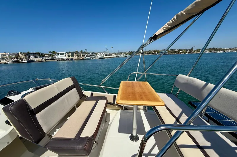 Slide: The Image of Flybridge seating area on a 2015 Cutwater C-30 CB boat, overlooking a marina. - 58