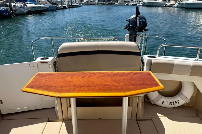 Slide: The Image of 2015 Cutwater C-30 CB boat with wooden table, docked at marina. - 62