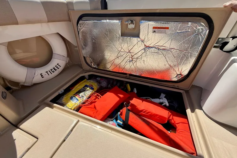 Slide: The Image of Storage compartment on a 2015 Cutwater C-30 CB boat with life jackets and safety gear. - 63