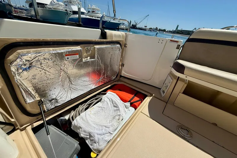 Slide: The Image of Storage compartment of a 2015 Cutwater C-30 CB boat, featuring various boating equipment. - 64