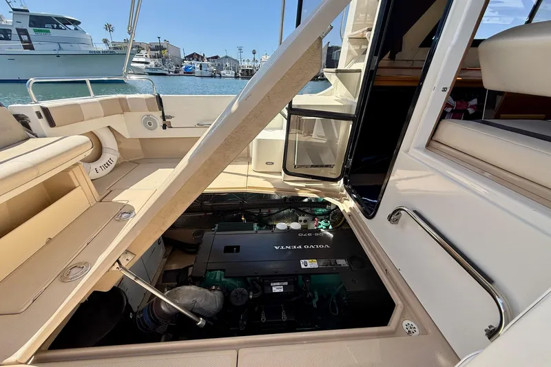 Slide: The Image of 2015 Cutwater C-30 CB boat with open engine compartment, docked in a marina. - 66