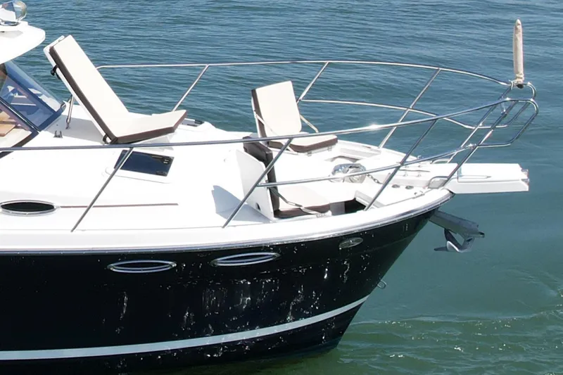 Slide: The Image of 2015 Cutwater C-30 CB boat with deck chairs on calm water. - 7