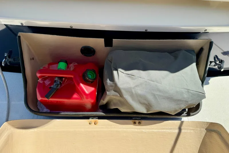 Slide: The Image of Storage compartment on a 2015 Cutwater C-30 CB boat with a red fuel container. - 74