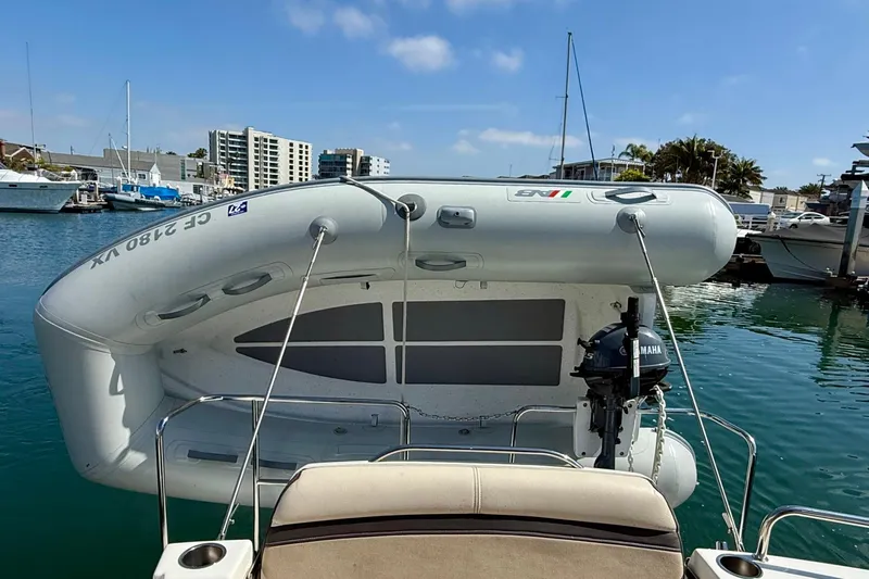 Slide: The Image of 2015 Cutwater C-30 CB boat with inflatable dinghy and Yamaha motor in marina setting. - 9