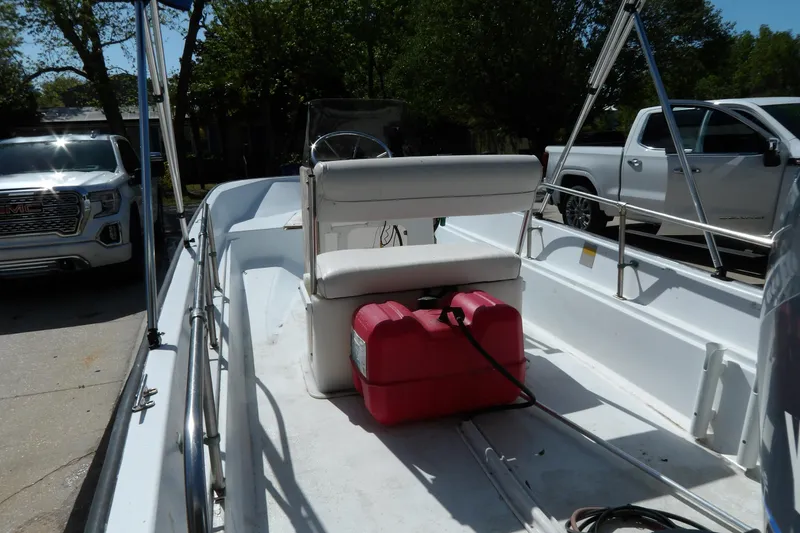 Slide: The Image of 1982 Boston Whaler Montauk 17 CC boat interior with white seating and red fuel tank. - 13