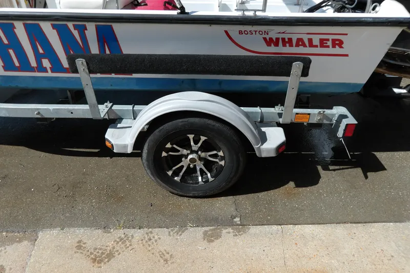 Slide: The Image of 1982 Boston Whaler Montauk 17 CC on trailer, showcasing side view and wheel detail. - 15