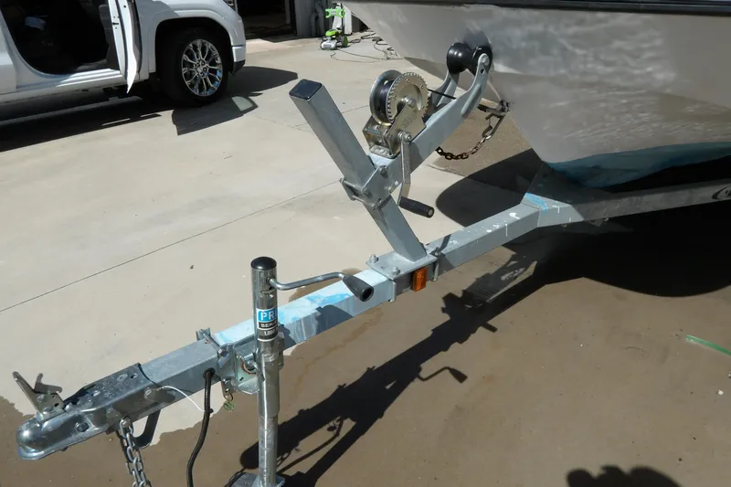 Slide: The Image of 1982 Boston Whaler Montauk 17 CC on trailer, parked beside a white vehicle. - 16