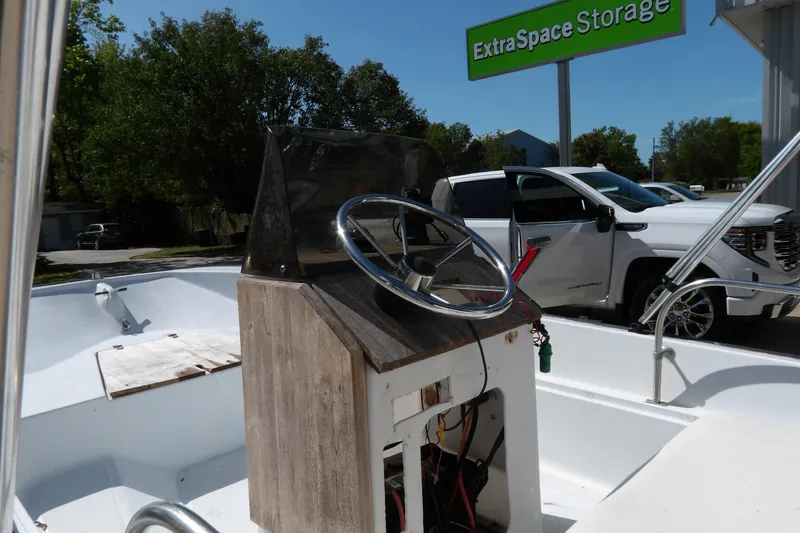 Slide: The Image of 1982 Boston Whaler Montauk 17 CC boat with steering console, parked near Extra Space Storage. - 7